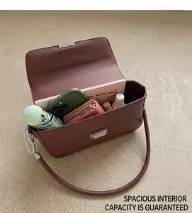 Internal view of brown leather crossbody bag showing spacious capacity for daily essentials