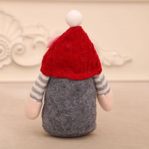 Back view of a Christmas gnome doll with a red knitted hat and striped sleeves decor