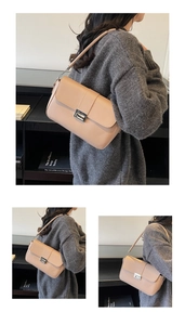 Detail view of the apricot square shoulder bag with silver metal lock and leather strap