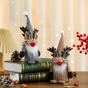 Standing Christmas gnomes with reindeer antlers and long white beards on books