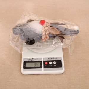 Christmas gnome doll with brown antlers weighing 89g on a scale in its package