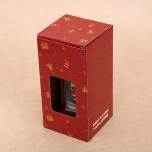 Close-up of a festive red Christmas lantern gift box with a transparent window display