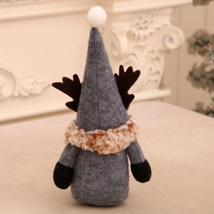 Detailed view of handmade Christmas gnome with grey felt body and brown reindeer antlers