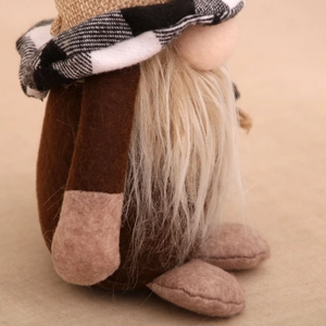 Close-up of a coffee gnome doll with a checkered hat and soft faux fur white beard