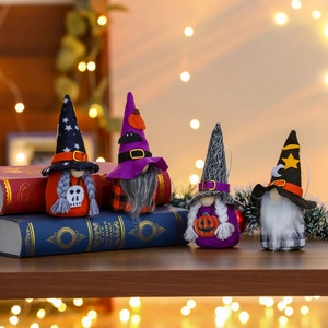 Set of four Halloween gnomes with pumpkin and bat motifs on rustic wooden table