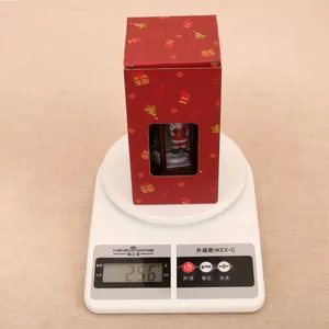 Detailed view of a red Christmas lantern gift box on a scale weighing 256g for weight check