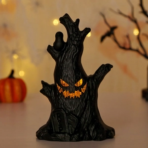 Halloween glowing dead tree figurine with glowing pumpkin face and RIP gravestone