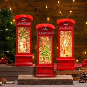 Three red Christmas telephone booth lanterns with snowmen and Santa figurines