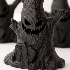 Macro shot of Halloween ghost tree trunk decoration with detailed RIP tombstone texture