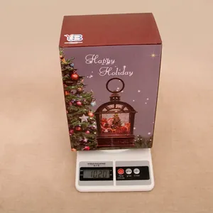 Christmas gift box with music box showing gross weight of 1020g on digital scale
