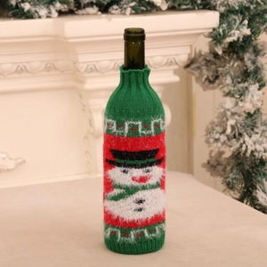 Detail of knitted Christmas wine bottle cover with snowman pattern for table decor