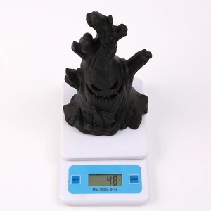 Black spooky tree stump with RIP tombstone Halloween LED light weighing 48g on scale