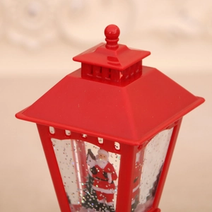 Macro detail of a red Christmas lantern with Santa scene and swirling glitter water