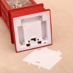 Detailed base view of Christmas telephone booth light with battery compartment and switch