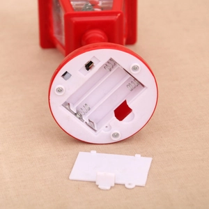 Detail view of the red Christmas lantern base showing battery compartment and power switch