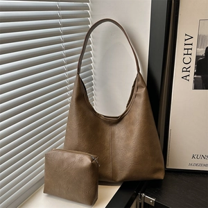 Large dark brown leather hobo tote bag with matching zipper pouch and minimalist style