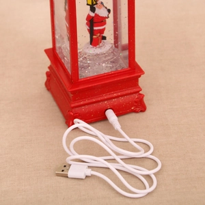 Close-up of the USB power port and cable for the red Christmas musical spinning lantern