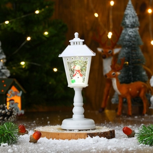 Detailed close-up of a white Christmas lantern with a snowman and snow globe effect
