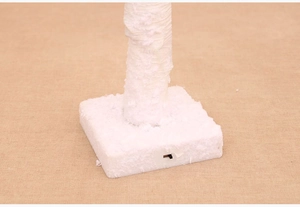 Detail of white snowy Christmas tree base with manual toggle switch and square stand