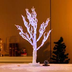Close-up of 65cm white birch-style LED Christmas tree with cold white lights on a base