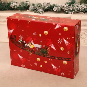 Detailed view of a red Christmas train gift box with festive patterns and snowflakes