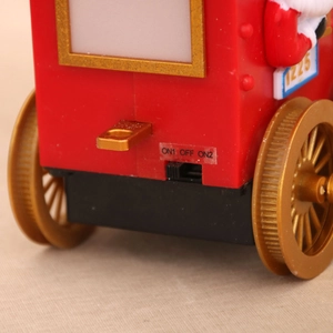 Macro view of Christmas train engine showing the three-way power switch and 1225 detail