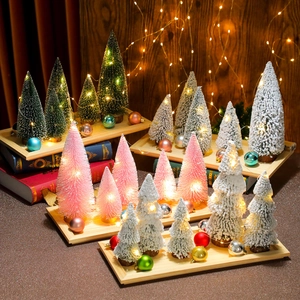 Mini LED Christmas trees in green, pink, and white on a solid wooden base for decor