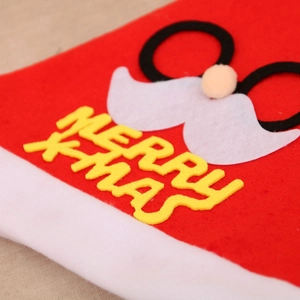 Close-up of Santa hat with MERRY XMAS text and fuzzy beard applique detail