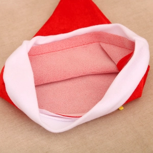Detail view showing stitching and plush texture of inner red and white Christmas hat