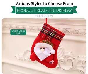 Detail of red Santa Claus Christmas stocking hanging on a white decorative fireplace