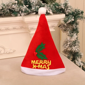 Detail of red Christmas hat featuring yellow Merry X-mas lettering and holly leaf decor