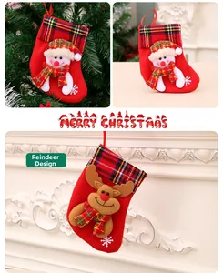 Detail of Christmas stockings with snowman and reindeer patches on a festive red background