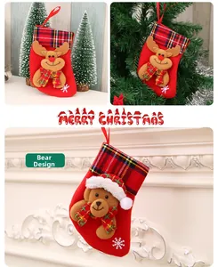 Detailed view of plush reindeer and bear Christmas stockings with festive plaid cuffs