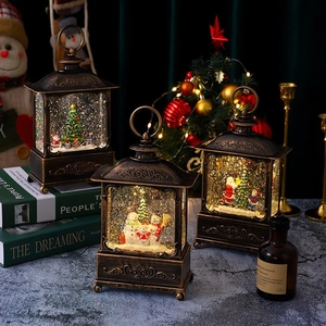 Close-up of three vintage bronze Christmas lanterns with warm LED lights and glitter