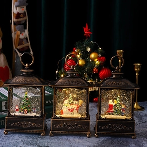 Close-up of three vintage bronze Christmas lanterns with snow scenes and warm light