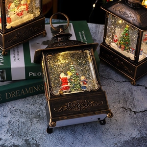 Retro bronze Christmas lantern detail with LED light and shimmering glitter sand effect