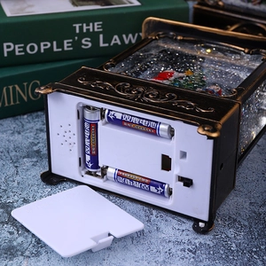 Detail view of the vintage Christmas lantern base with battery compartment and switch