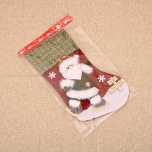 Detail of a large velvet Christmas stocking with 3D Santa Claus and Merry Christmas sign