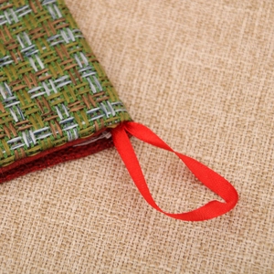 Detail of large velvet Christmas stocking with green and yellow textured knit pattern