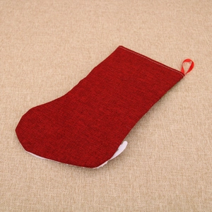 Detail of red burlap Christmas stocking with textured fabric and silk hanging loop