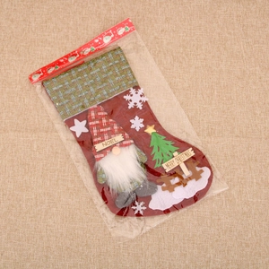 Detail of burlap Christmas stocking featuring a 3D faceless gnome and Noel wooden tag