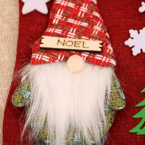 Detail of burlap Christmas stocking featuring a gnome with NOEL sign and white beard