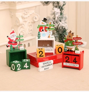 Detailed view of red, white, and green wooden Christmas countdown calendars with festive motifs
