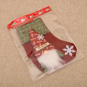 Detail of linen Christmas stocking with gnome and HO HO HO slogan in retail packaging