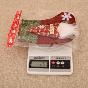 Christmas stocking made of red burlap and plaid fabric with a gnome and snowflake detail