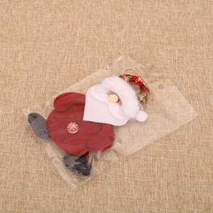 Detail of Santa fabric ornament with snowflake button and plaid hanging loop