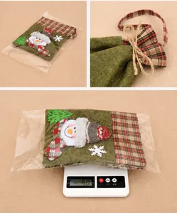 Detail view of plaid fabric Christmas gift bag with snowman and weight measurement