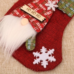 Detail of burlap Christmas stocking with faux fur beard and HO HO HO wood plaque decoration