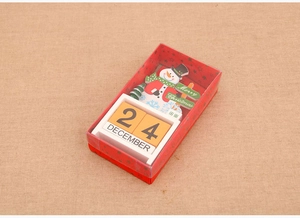 Detail view of snowman wooden Christmas calendar box with date blocks and festive decor