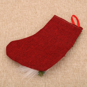 Detail of red burlap Christmas stocking with vintage texture and white faux fur trim